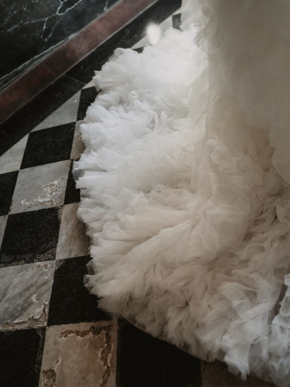 Villa Pizzo | Lago di Como 4 Wedding dress train draped over black and white floor tiles at Villa Pizzo